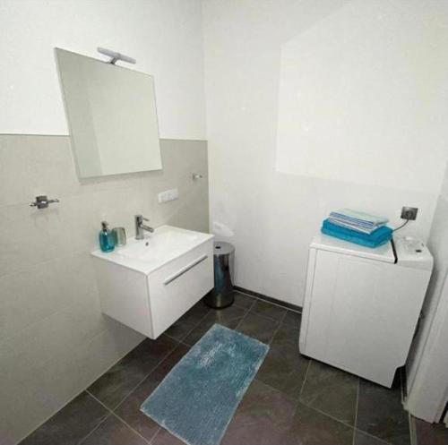 a white bathroom with a sink and a mirror at International 6 in Bad Harzburg