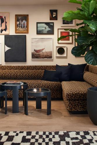 a living room with a couch and two tables at Kimpton Alton Fisherman's Wharf by IHG in San Francisco