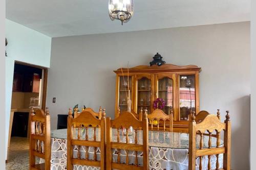 a room with a wooden cabinet and two beds at Casa Marquita en el centro de Talpa de Allende. in Talpa de Allende