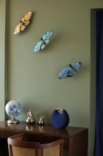three butterflies on the wall above a table at Gaia Lodge in Tupungato