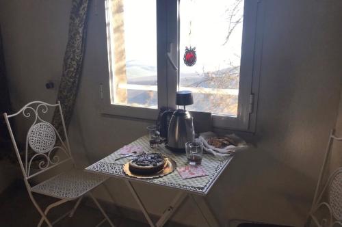 a table with a coffee maker and a window at La Tosca in Laiatico