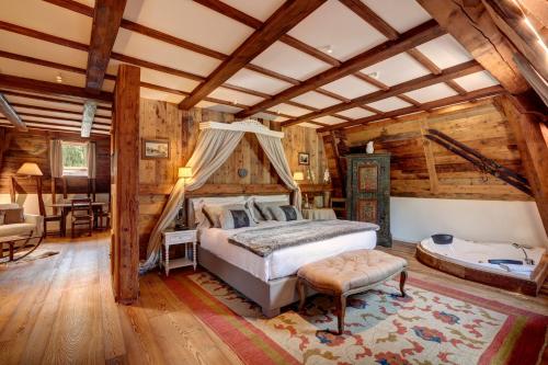 a bedroom with a bed and a tub in a room at Grand Hôtel des Alpes in Chamonix-Mont-Blanc