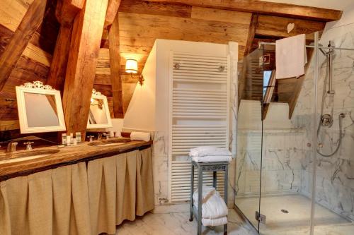 a bathroom with a shower and a sink at Grand Hôtel des Alpes in Chamonix-Mont-Blanc