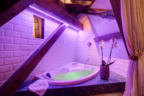 a bathroom with a bath tub and a toilet at Grand Hôtel des Alpes in Chamonix