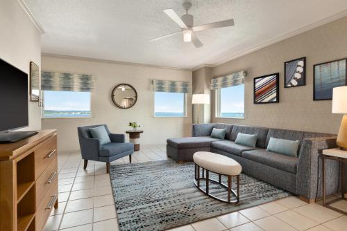 a living room with a couch and a tv at Holiday Inn & Suites Ocean City by IHG in Ocean City