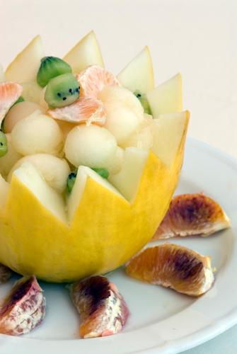a fruit cut in half on a white plate at Hotel Terme Villa Teresa in Ischia