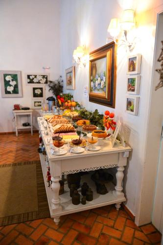 a buffet of food on a table in a room at Pousada Vale Dos Figos in Urussanga