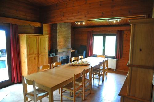 a dining room with a large wooden table and chairs at Gite L'unité in Hour