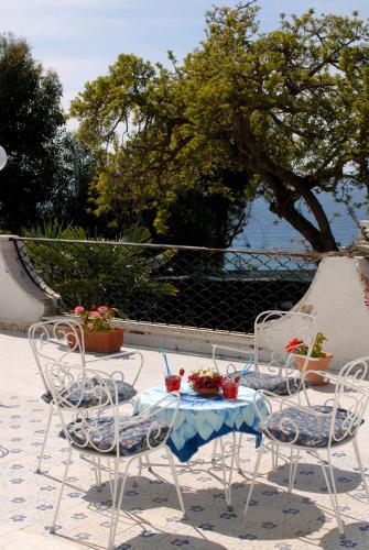 a table and chairs with a meal on it at Hotel Terme Villa Teresa in Ischia
