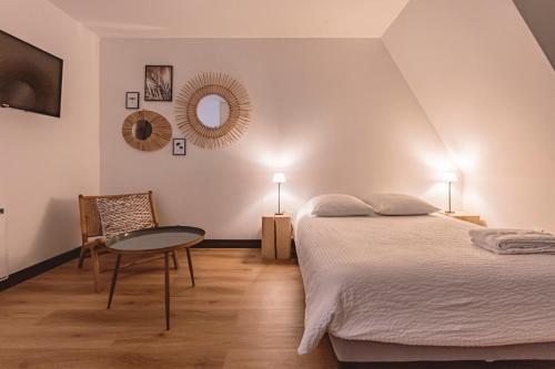 a bedroom with a bed and a table at Reims - Place du Forum - Cathédrale - City Center in Reims
