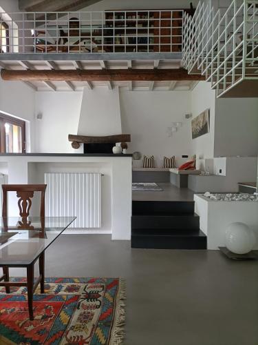a living room with a glass table and a rug at Villa Rustico in Viboldone