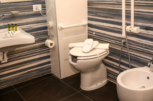 a bathroom with a toilet and a sink at Bed and Breakfast Terra del Sole Ibla in Ragusa