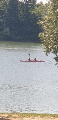 two people in a kayak on a body of water at Vila Sava in Jarak