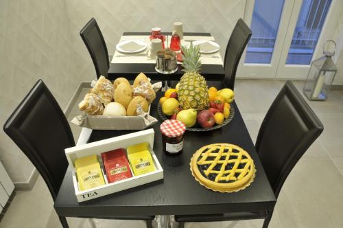a table with fruits and vegetables on top of it at Gemini Suite in Rome