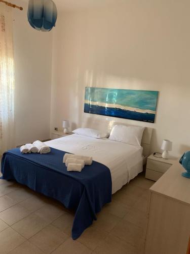 a bedroom with a bed with two towels on it at La Villetta al Mare in Porto Cesareo