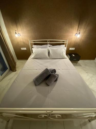 a large white bed with two towels on it at Joanna's apartments in Virós