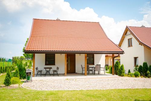 a white house with a red roof at Mazurskie El Dorado in Mikołajki