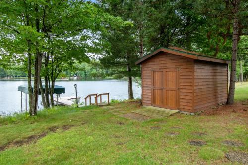 a small wooden shed next to a body of water at GolfView GetAway in Eagle River