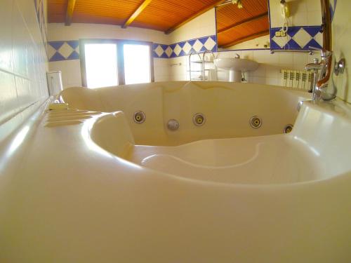 a large white bath tub in a bathroom at Hotel Paraiso de Bujaraiza in Coto Ríos