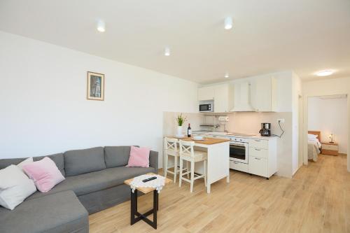 a living room with a couch and a kitchen at Guest House Anica in Dubrovnik