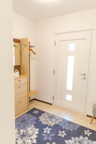 a room with a door and a rug at Domizil Illmitz in Illmitz
