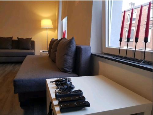 a living room with a couch and a coffee table at Charmante maison lumineuse au coeur de Liège! in Ans