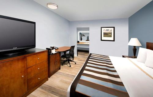 a hotel room with a bed and a flat screen tv at Ivy City Hotel in Washington, D.C.