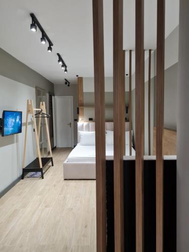 a bedroom with a bed and a tv in a room at TAM Center Studio Apartment Next To Blloku No1 in Tirana