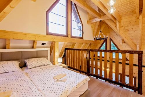 a bedroom in a log cabin with a bed at Wood Fairy in Korenica