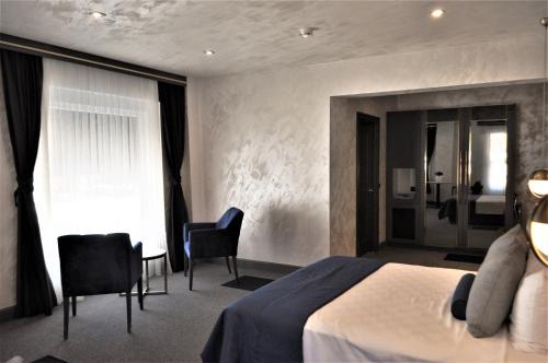 Ένα ή περισσότερα κρεβάτια σε δωμάτιο στο Skopea Inn Exclusive Hotel