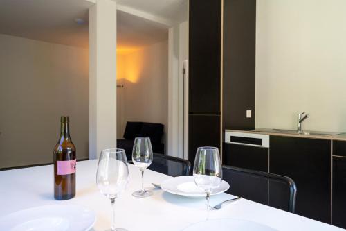 a bottle of wine and two wine glasses on a table at Villa Pineta in Fusio