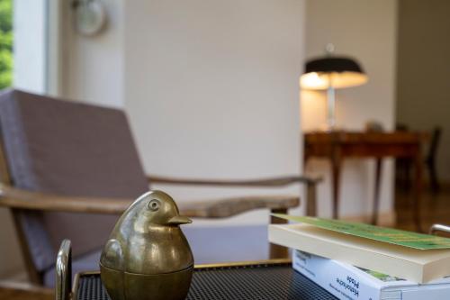 a bird figurine sitting on a table next to a book at Villa Pineta in Fusio
