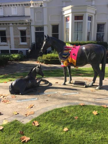 a statue of a horse and a dog on a sidewalk at Kingsley Quarters in Cambridge
