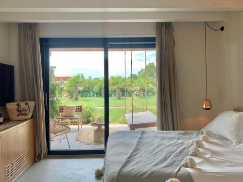 a bedroom with a bed and a sliding glass door at Santa Lucia Maccarese - Residenza Agricola in Maccarese