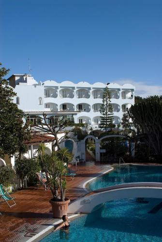 a hotel with a swimming pool in front of a building at Hotel Terme Villa Teresa in Ischia