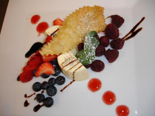 a plate of food with fruit on a white plate at Hotel Ambassador in Bern