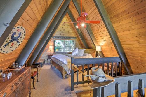 a attic bedroom with a bed and a ceiling fan at Irwin A-Frame Cabin with Deck and Mountain Views! in Irwin