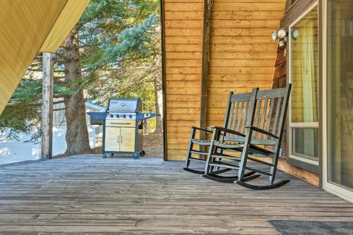 a grill and two chairs sitting on a porch at Irwin A-Frame Cabin with Deck and Mountain Views! in Irwin