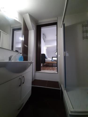 a bathroom with a sink and a mirror at Fiori Apartment in Gevgelija