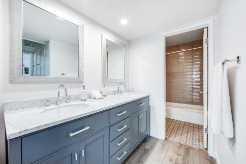 a bathroom with a blue sink and a mirror at Mountain View Modern Condo Permit# 4340 in Palm Springs