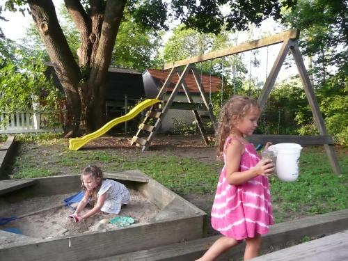 two young children playing in a sandbox in a sandbox at Aunt Jane's Victorian Manor in Put-in-Bay