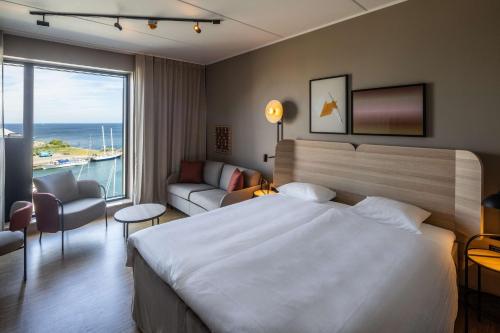 a hotel room with a bed and a large window at Scandic CPH Strandpark in Copenhagen
