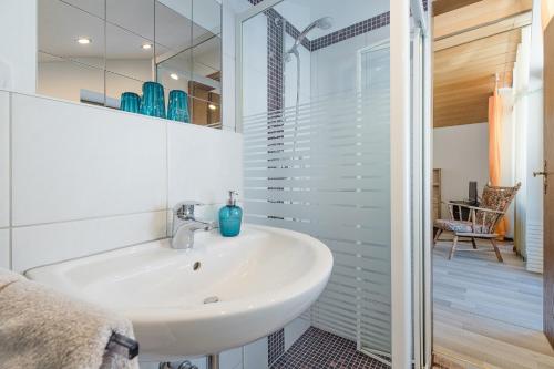 a white bathroom with a sink and a shower at Gästehaus Friedlich in Schönau am Königssee