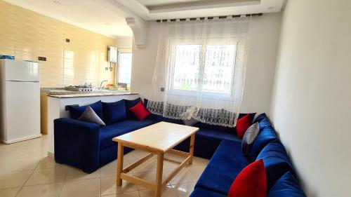 a living room with a blue couch and a table at Enjoy Your Vacation Here, Close to The Beach, Only 1 minute Walk!! in Martil