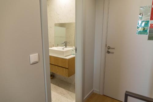 a bathroom with a sink and a mirror at Sal, Terra e Mar in Aveiro