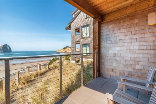 a house with a balcony with a view of the beach at Headlands Coastal Lodge & Spa in Pacific City