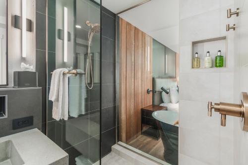 a bathroom with a shower with a sink and a toilet at Headlands Coastal Lodge & Spa in Pacific City