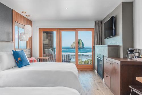 a hotel room with a bed and a view of the ocean at Headlands Coastal Lodge & Spa in Pacific City