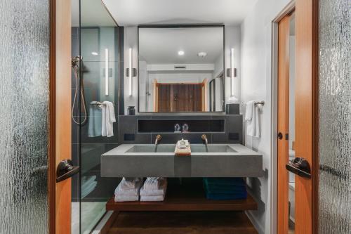 a bathroom with a sink and a mirror at Headlands Coastal Lodge & Spa in Pacific City