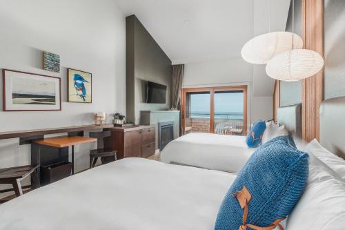 a person laying on a bed in a hotel room at Headlands Coastal Lodge & Spa in Pacific City